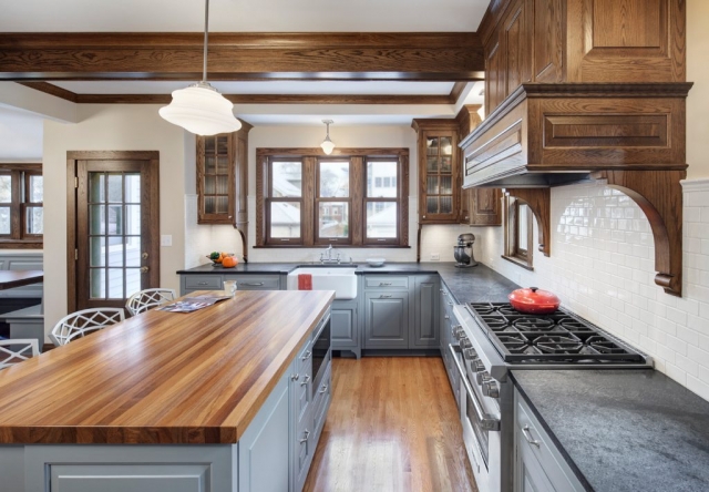 Teak countertop at island and traditional wood cabinetry